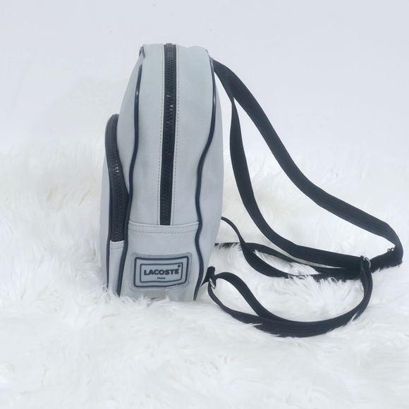 Lacoste mini backpack in a soft light blue shade with navy blue trim accents. - Picture 8 of 16